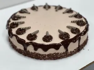 Chocolate mousse cake with chocolate drizzle and rosettes