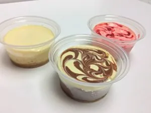 Three cheesecake cups: plain, marble swirl and strawberry
